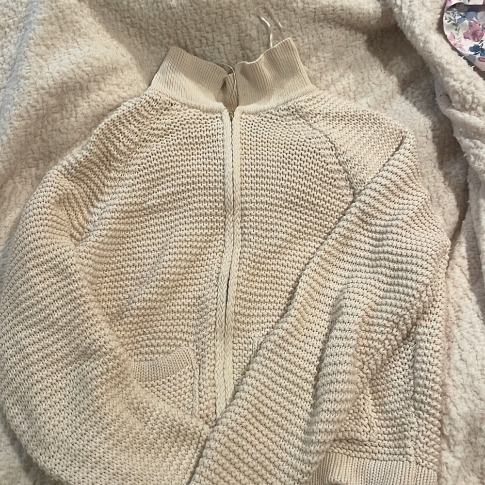 A beige crochet short jacket